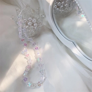 Macro view of iridescent acrylic star beads on a stylish mobile phone lanyard charm