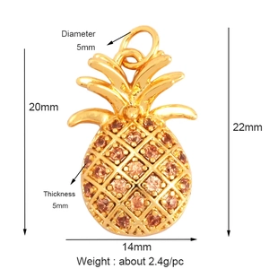 Detail view of a gold-plated pineapple pendant with amber stones and dimensions