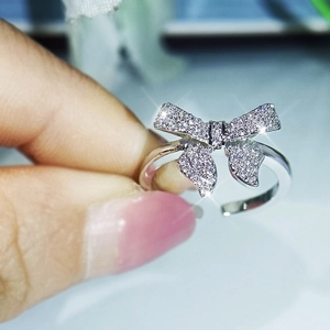 Elegant silver bow ring with sparkling zircon stones in a detailed close-up view