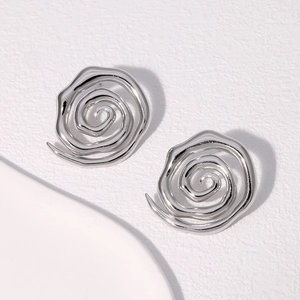 Detailed view of silver minimalist spiral earrings with modern stainless steel texture