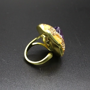 Vintage gold open ring featuring large amethyst stone and faceted yellow accents