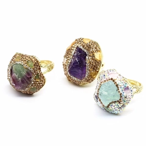 Vintage gold-tone rings featuring large raw amethyst and natural stone clusters