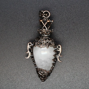 Detailed view of vintage copper hollow pendant with a translucent white crystal stone