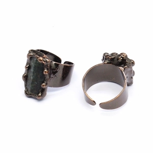 Detail of adjustable vintage bronze rings with large dark rectangular agate geode stone