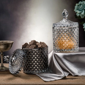 Detail of diamond-textured crystal glass jars in clear and smoky grey with lids