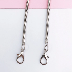 Detailed view of silver snake chains with lobster clasps for mobile phones or bags