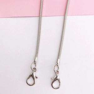 Detail of silver snake chain strap with metal texture and secure lobster clasp closure