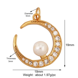 Close-up of golden crescent moon pendant with white zircons and center pearl detail