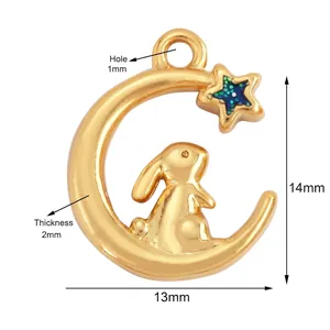 Detailed view of golden crescent moon pendant with blue glitter star and bunny charm