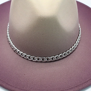 Detail of wool felt jazz hat featuring sand crown, dusty pink brim and metal chain