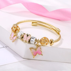 Gold beaded bangle with pink gradient butterfly charms and spiral texture for women