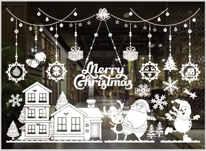 Detail view of white Christmas window decals featuring Santa, snowman, and snowflake patterns