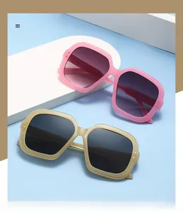 Detail of pink and brown oversized square sunglasses with metal rivets and gradient lenses