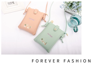 Detail view of light orange and mint green leather mini phone bags with snap closure
