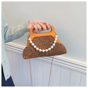 Detail of tweed evening bag featuring a natural wooden handle and pearl chain accessory