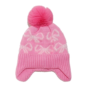 Pink knitted baby winter hat with white bow pattern and soft fluffy pom pom on top