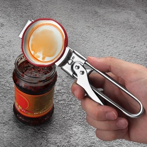 Adjustable stainless steel jar opener tool opening a glass bottle on grey background