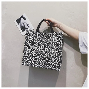 Detail of leopard print canvas tote bag with sturdy black strap for shopping