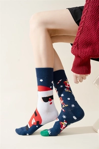 Detail of navy blue Christmas socks featuring Santa Claus and snowflake knitted patterns