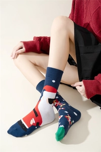 Detail of Christmas crew socks with Santa Claus pattern and knitted texture on foot