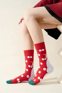 Close-up of red Christmas socks with snowman patterns and reinforced green toe details