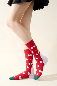 Detail of red Christmas crew socks featuring snowman patterns and green toe patchwork