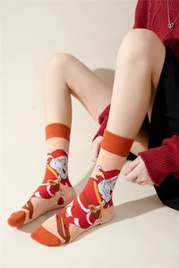 Close-up of cotton Christmas crew socks featuring Santa Claus pattern and ribbed cuffs