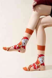 Detailed knit texture of orange and pink Christmas socks with Santa Claus patterns