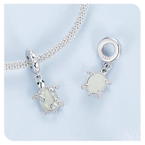 Detailed S925 sterling silver sea turtle charm with green gems and luminous shell