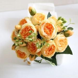 Close-up of artificial orange peony bouquet with detailed silk petals and green buds