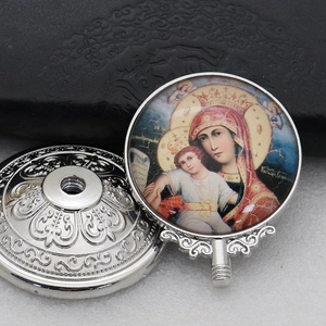 Macro shot of an Orthodox metal pendant featuring the Madonna and Child icon