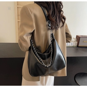 Detail shot of the black PU leather hobo bag with white stitching and chain strap