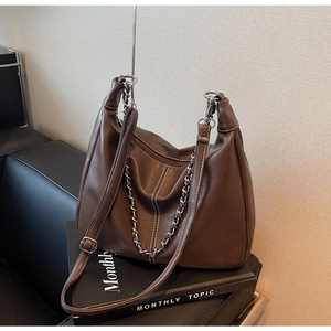 Detail view of the brown soft leather shoulder bag with silver chain and adjustable strap
