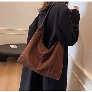 Detail of dark brown suede hobo bag showing large capacity and soft matte texture
