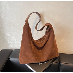 Brown suede tote bag with large capacity shown in a minimalist lifestyle setting