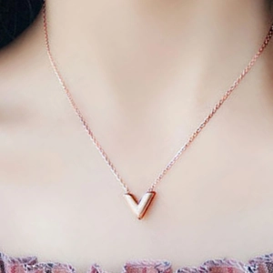 Minimalist V-shaped necklace in rose gold finish worn on neck for a stylish look