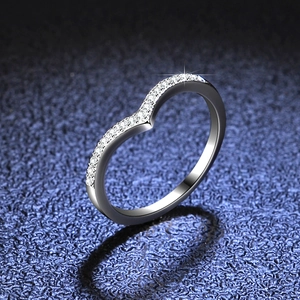 Macro detail of V-shaped silver crown ring with sparkling pavé cubic zirconia accents