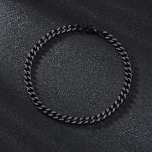 Close-up of black plated stainless steel Cuban link bracelet with metallic highlights
