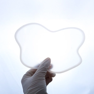 Translucent butterfly silicone mold for resin casting held by hand to show size