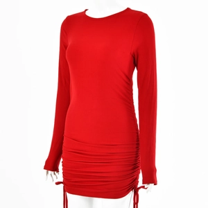 Macro detail of red long-sleeve dress featuring adjustable side drawstring and ribbed fabric