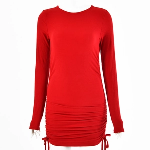 Detail view of red knitted long sleeve dress featuring side drawstring and ruched texture