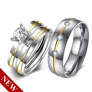Detailed view of silver and gold two-tone couple rings with brilliant cut crystals