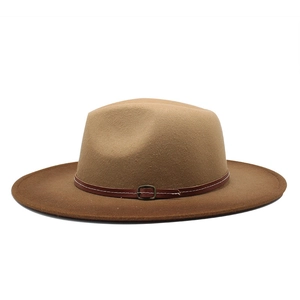Detailed macro view of the fedora hat's leather band and vintage metal buckle