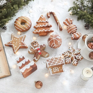 Assorted gingerbread style Christmas tree ornaments set with snowflakes and stars shapes