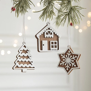 Wooden Christmas hanging ornaments featuring tree, house and snowflake on pine branch