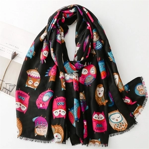 Black cotton linen feel scarf with colorful owl pattern and fringe on white background