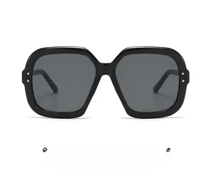 Detailed view of black square oversized sunglasses with silver metal rivet accents
