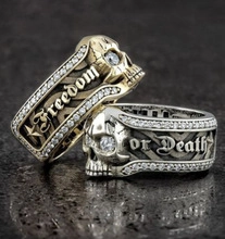 Detail showing skull design ring with clear cubic zirconia and Freedom or Death engraving