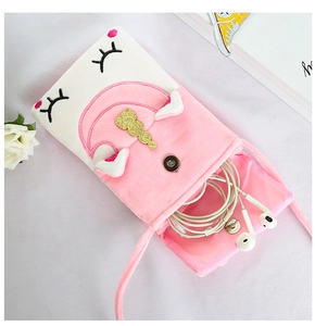 Detail of plush unicorn crossbody bag interior showing storage space for headphones