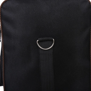 Close-up of durable metal D-ring buckle and reinforced black fabric strap on travel bag